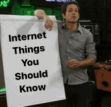 a man holds a white board that says internet things you should know