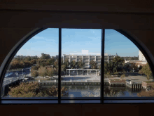 a view of a city from a window with a building in the background