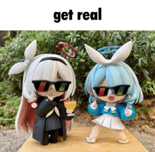 two dolls wearing sunglasses are standing next to each other with the caption get real