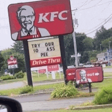 a kfc sign that says try our $ 0 ass pee drive thru .