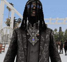 a man with dreadlocks is wearing sunglasses and a necklace with a pendant that says ' a '