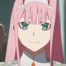 zero two from darling in the franxx is a pink haired anime girl with green eyes .