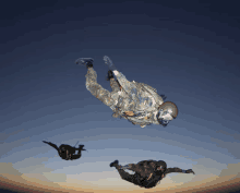 a man in a camouflage uniform is flying through the air with another man