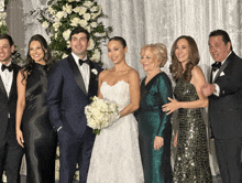 the bride and groom are posing for a photo with their family