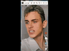 a man 's face is displayed on a cell phone with the app lets vlog