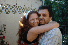 a man and a woman are posing for a picture and the woman is wearing a headband