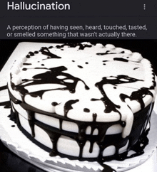 a black and white cake with the word hallucination on the top