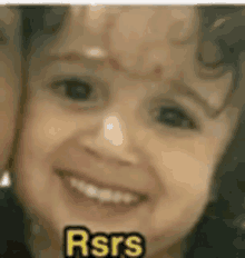 a close up of a child 's face with the words rsrs written below it