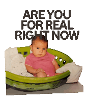 a baby is sitting in a green laundry basket with the words " are you for real right now " above it