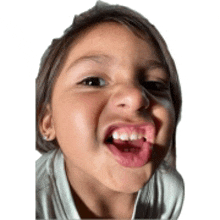 a little girl is sticking her tongue out and making a funny face