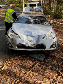 a silver car with a license plate that says eqs 09k