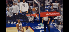 a basketball player wearing a vote shirt stands on the court