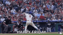 a baseball player is swinging a bat at a ball in front of a crowd while a referee watches .