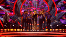a group of people are on a stage with dancing brasil written on the bottom