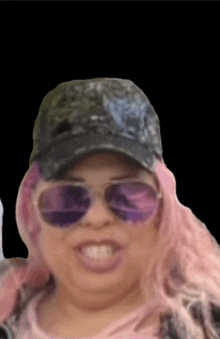 a woman with pink hair wearing sunglasses and a baseball cap