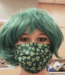 a woman wearing a green wig and a green mask with clovers on it