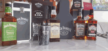 several bottles of jack daniel 's whiskey are on a table