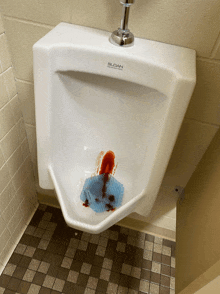 a urinal with blood coming out of it and the word sudan on the top