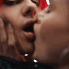 a woman with red hair is kissing herself in the mirror