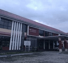 a large building with a red tile roof and a lot of windows .