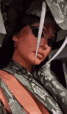 a close up of a woman 's face wearing a hat and gloves