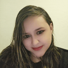 a close up of a woman 's face with long hair and red lips