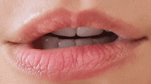 a close up of a woman 's mouth with pink lips