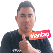 a man is giving a thumbs up with a sticker that says mantap