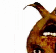 a close up of a cartoon character 's face with its mouth open and horns .