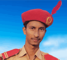 a young man wearing a red beret with a feather on top