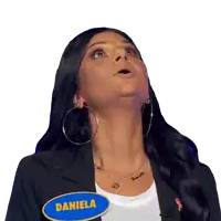 a woman is wearing a name tag that says daniela