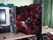 a computer case is covered in blood and looks like it has been eaten by a zombie