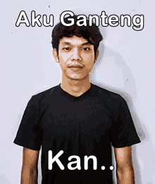 a man wearing a black shirt with aku ganteng kan written on the front