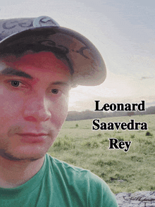 a man wearing a hat and a green shirt with the name leonard saavedra rey on the bottom