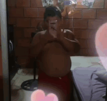 a man is taking a picture of himself in a mirror with a heart in the background