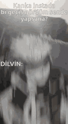 a black and white photo of a person 's face with the words dilvin written on it .