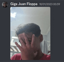 a screenshot of giga juan floppa covering his face