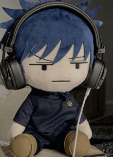 a stuffed animal wearing headphones has a sad face