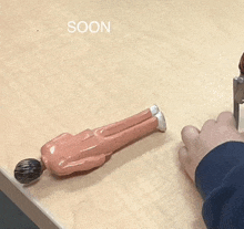 a person playing with a toy that says soon