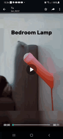 a video of a bedroom lamp is being played on a cell phone