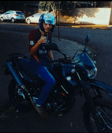 a man wearing a helmet is sitting on a motorcycle with a yamaha logo on the front