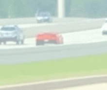 a blurry picture of a race car driving down a race track .