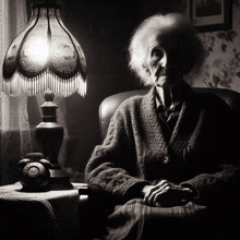 an elderly woman sits in a chair next to a lamp and a telephone that says ' telephone ' on the front