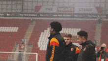 a group of soccer players are standing in a stadium with a sign that says ' new york stadium '