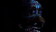 a close up of a clown in the dark with purple eyes .