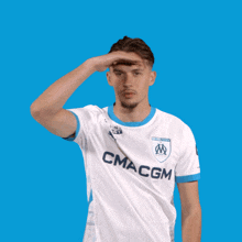 a man wearing a white shirt that says cma cgm on it