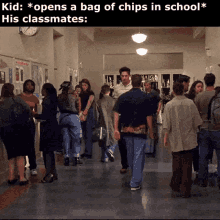 a group of people are walking down a hallway in a school while a kid opens a bag of chips in school .