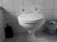 a toilet with two rolls of toilet paper on the lid