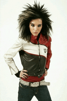 a woman with a mohawk wearing a leather jacket with a x on it