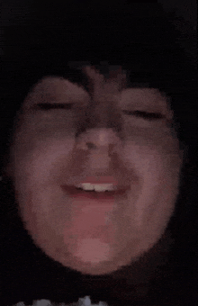 a pixelated image of a person 's face with their eyes closed .